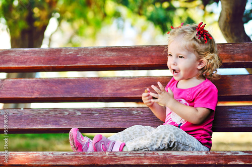 Photo: сute toddler on the bench сute toddler on the bench