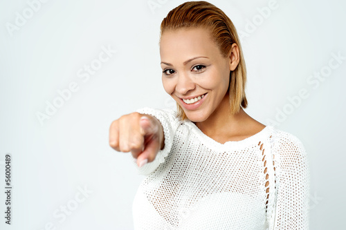 Photo: Cheerful young lady pointing you out Cheerful young lady pointing you out