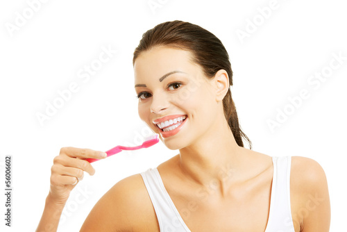 Photo: Young beautiful woman washing her teeth Young beautiful woman washing her teeth