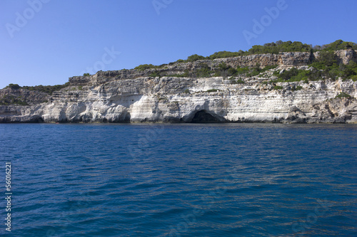 Photo: Natural caves on the coast of Menorca, Mediterranean sea, Spain. Natural caves on the coast of Menorca, Mediterranean sea, Spain.