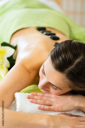 Photo: woman having wellness hot stone massage woman having wellness hot stone massage