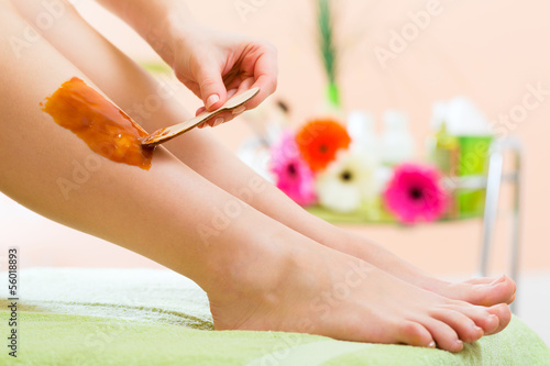 Photo: Woman in Spa getting leg waxed for hair removal Woman in Spa getting leg waxed for hair removal