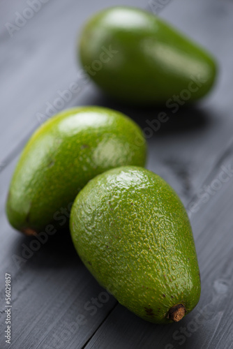 Photo: Close-up of avocado pears on black wooden boards Close-up of avocado pears on black wooden boards
