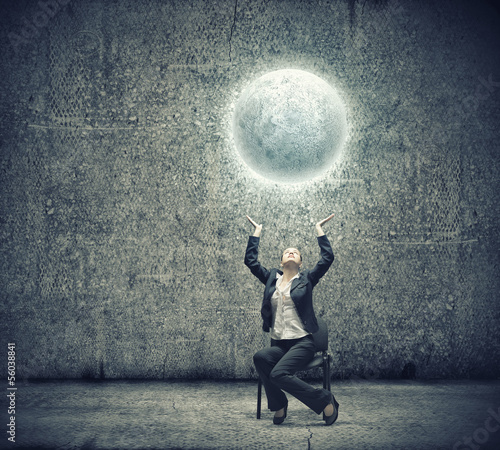 Photo: Businesswoman holding moon Businesswoman holding moon