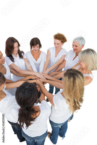 Photo: Happy female models joining hands in a circle Happy female models joining hands in a circle