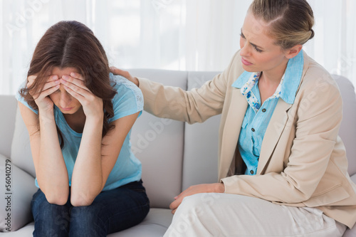 Photo: Worried woman being comforted by her therapist Worried woman being comforted by her therapist