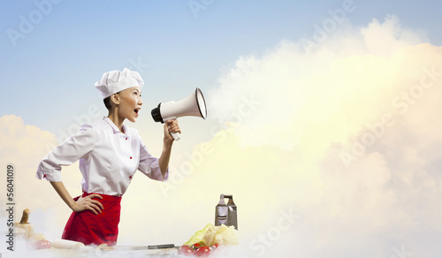 Photo: Asian female cook holding megaphone Asian female cook holding megaphone