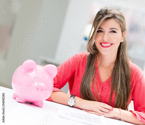 Photo: Business woman with a piggybank Business woman with a piggybank