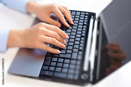 Photo: Hands with laptop computer keyboard. Hands with laptop computer keyboard.
