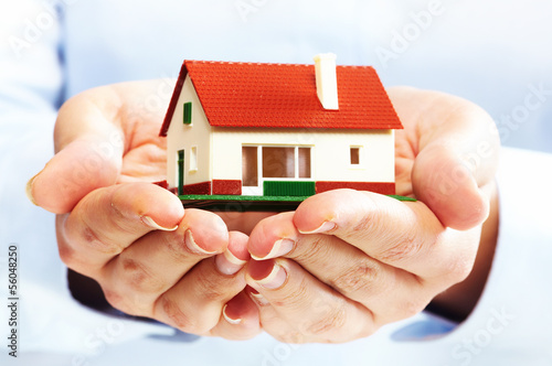 Photo: Hands with little house. Hands with little house.