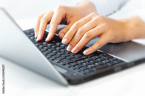 Photo: Hands with laptop computer keyboard. Hands with laptop computer keyboard.