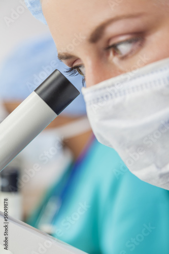 Photo: Female Woman Scientist Using Microscope in Laboratory Female Woman Scientist Using Microscope in Laboratory