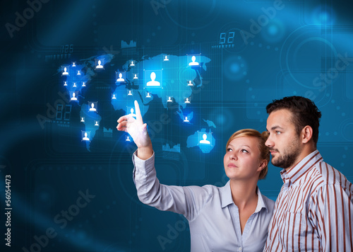 Photo: Young couple choosing from social network map Young couple choosing from social network map