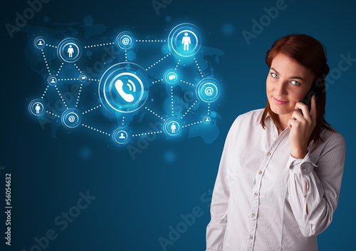 Photo: Pretty girl making phone call with social network icons Pretty girl making phone call with social network icons