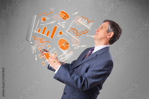 Photo: Businessman holding notebook with graphs and statistics Businessman holding notebook with graphs and statistics