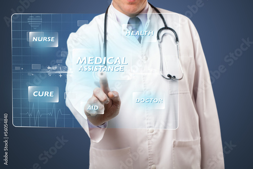 Photo: Middle aged doctor pressing modern medical type of button Middle aged doctor pressing modern medical type of button