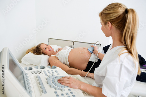 Photo: Pregnant Woman Getting Ultrasound From Female Doctor Pregnant Woman Getting Ultrasound From Female Doctor