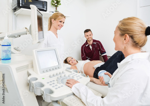 Photo: Gynecologists And Expectant Couple In Clinic Gynecologists And Expectant Couple In Clinic