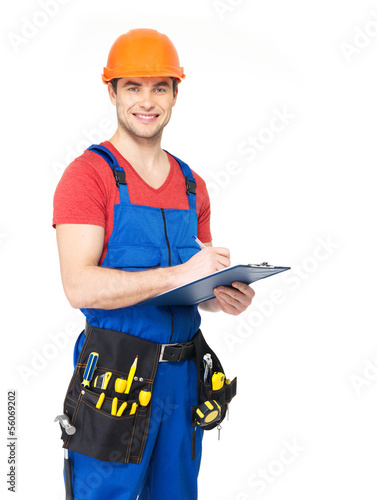 Photo: worker with tools, planning and writing the note worker with tools, planning and writing the note