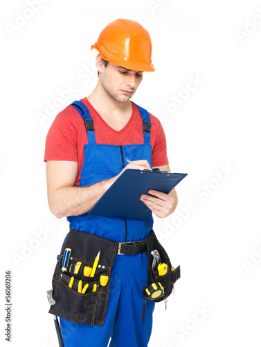 Photo: worker with tools, planning and writing the note worker with tools, planning and writing the note