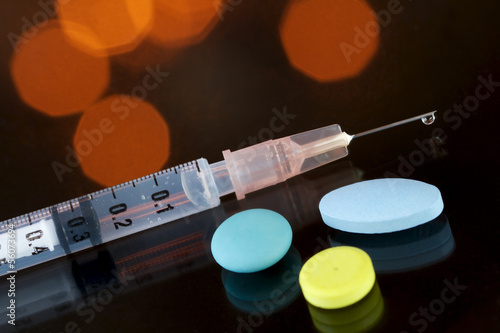 Photo: Syringe and painkillers Syringe and painkillers