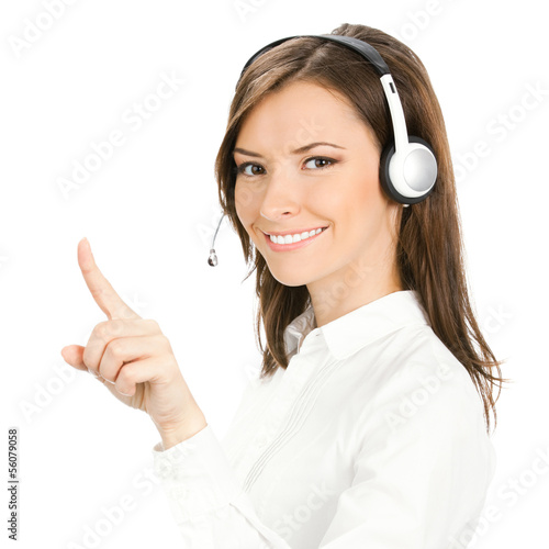 Photo: Young phone operator in headset pointing Young phone operator in headset pointing