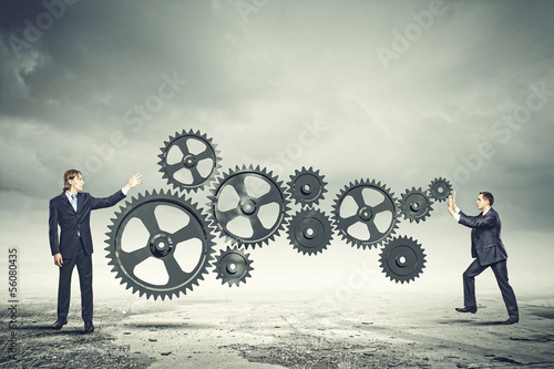 Photo: Businessman and mechanism elements Businessman and mechanism elements
