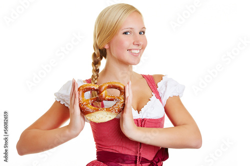 Photo: Happy woman in dirndl with pretzel Happy woman in dirndl with pretzel