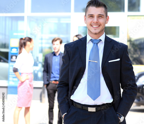 Photo: Happy smart business man with team mates discussing Happy smart business man with team mates discussing