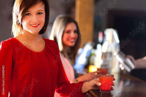 Photo: Friends having a round of drinks in a pub Friends having a round of drinks in a pub