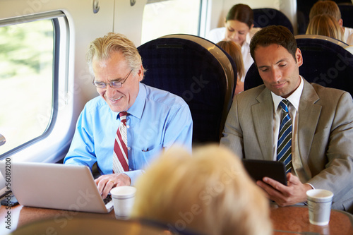 Photo: Businessman Commuting To Work On Train And Using Laptop Businessman Commuting To Work On Train And Using Laptop
