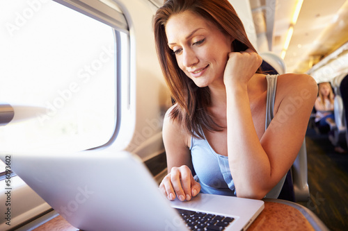Photo: Woman Using Laptop On Train Woman Using Laptop On Train