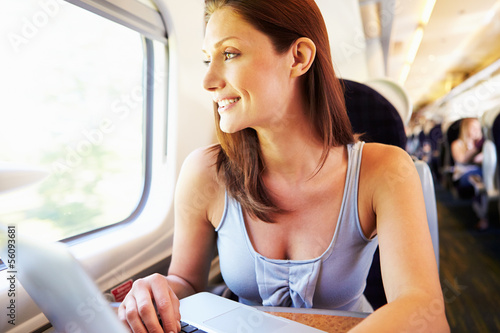 Photo: Woman Using Laptop On Train Woman Using Laptop On Train