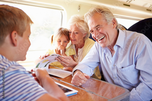 Photo: Grandparents And Grandchildren Relaxing On Train Journey Grandparents And Grandchildren Relaxing On Train Journey
