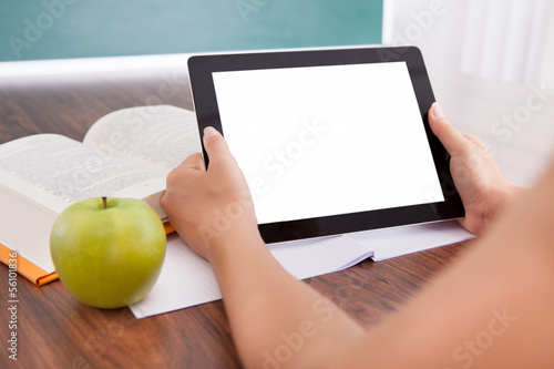 Photo: Student holding digital tablet Student holding digital tablet