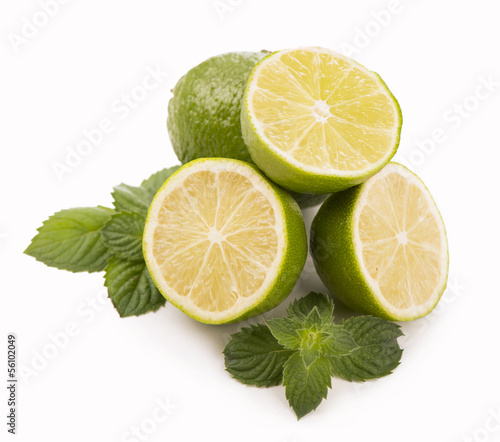 Photo: Fresh limes, mint leaves isolated on white Fresh limes, mint leaves isolated on white
