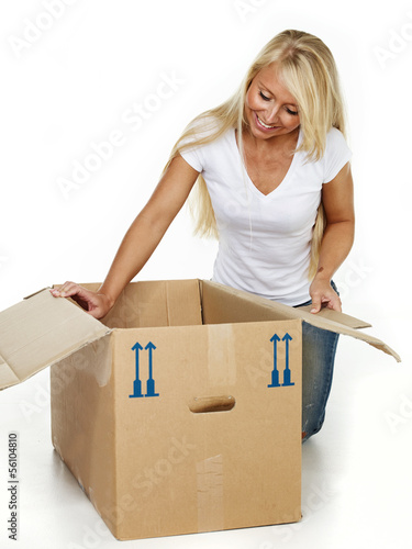 Photo: Woman clutching something in a moving box Woman clutching something in a moving box