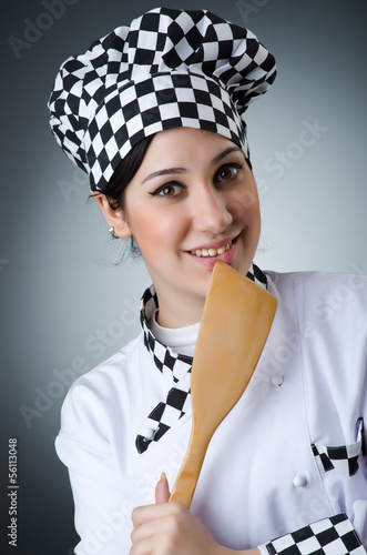 Photo: Pretty cook with kitchen utensils Pretty cook with kitchen utensils