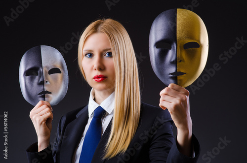 Photo: Woman with mask in hypocrisy concept Woman with mask in hypocrisy concept