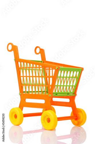 Photo: Plastic shopping cart against the white background Plastic shopping cart against the white background
