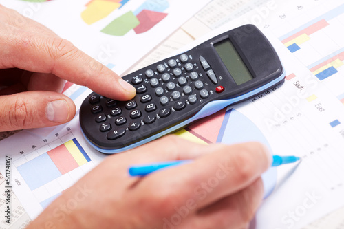 Photo: Hand with calculator. Hand with calculator.