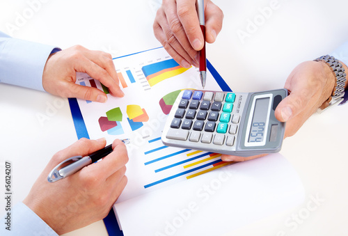 Photo: Hands of business people with calculator. Hands of business people with calculator.