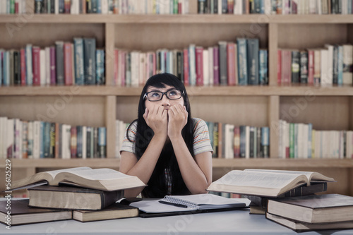 Photo: Asian female student worry at library Asian female student worry at library