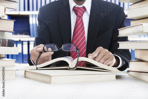 Photo: Businessman reading a book Businessman reading a book