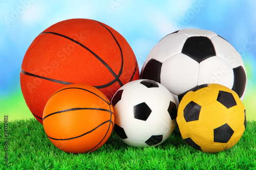 Photo: Sport balls, on green grass, on bright background Sport balls, on green grass, on bright background