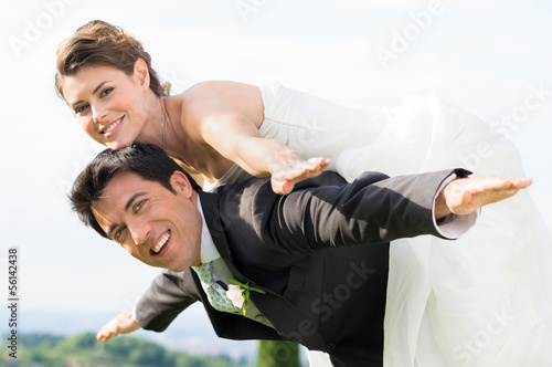 Photo: Bride and groom piggyback Bride and groom piggyback