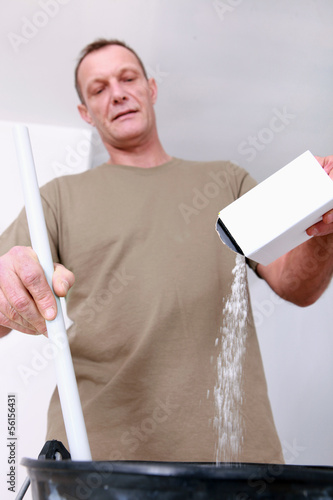 Photo: Worker mixing plaster Worker mixing plaster
