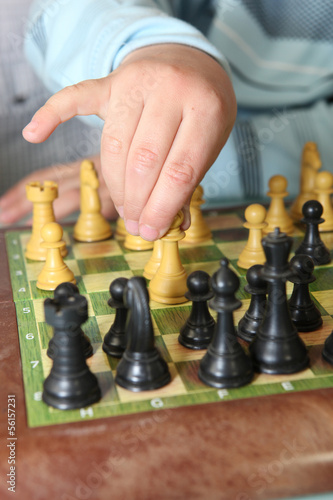 Photo: Close-up of little boy playing chess Close-up of little boy playing chess