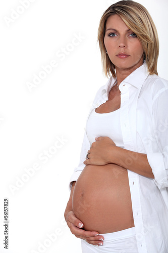 Photo: Woman touching her pregnant belly Woman touching her pregnant belly