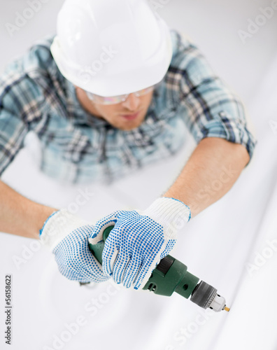 Photo: man drilling the wall man drilling the wall